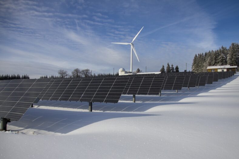 solar panels and wind turbine on snow